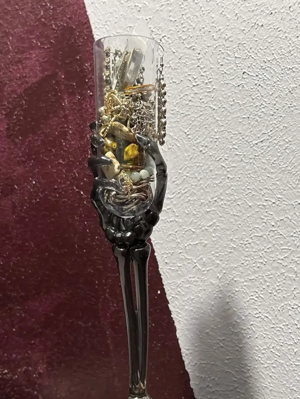 Trick or treat yourself to a skeleton hand on a flute full of jewelry